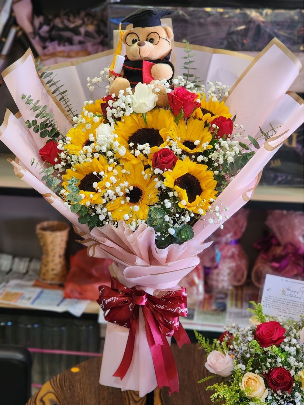 Medium Size : 5 Sunflower + 3 Daisy + 6 Rose Mix Graduation Bouquet + Small Teddy Bear + Baby Breath & Eucalyptus