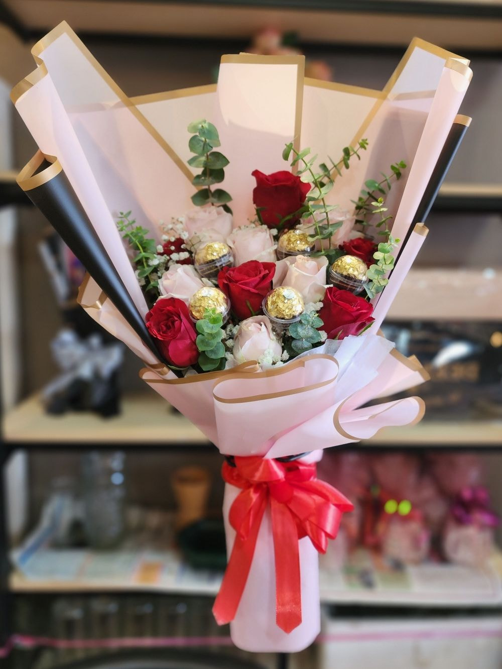 Medium size: 12rose mix color flower arrangements with 6 Ferrero Rocher, Baby Breath & Eucalyptus.